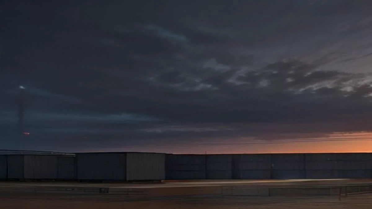 A containerised mining farm at dusk with warm work lights glowing under soft overcast daylight, seen from a low angle